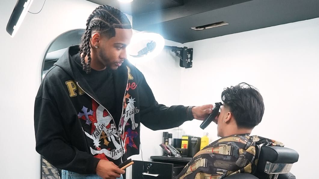 Inside AxellCuts barbershop at 260 W 135 St, Harlem NYC