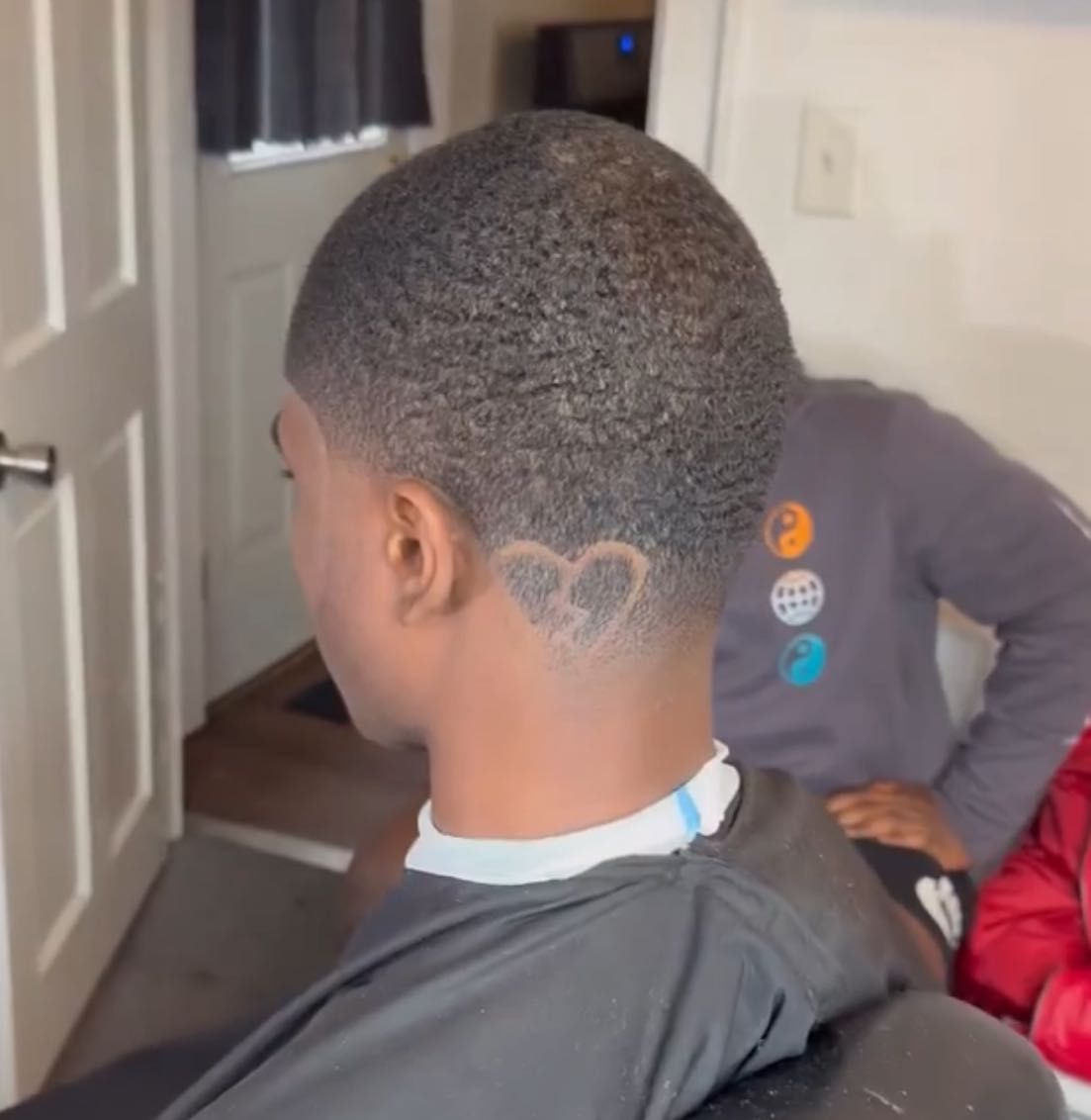 Barber at work inside AxellCuts, 260 W 135 St Harlem